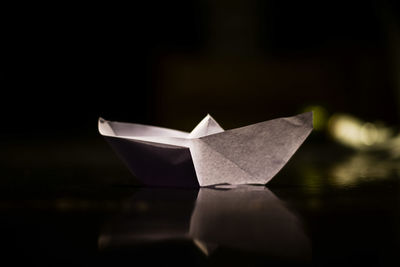 Close-up of paper boat on table