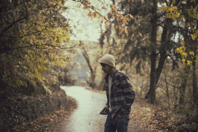 Rear view of man walking in forest