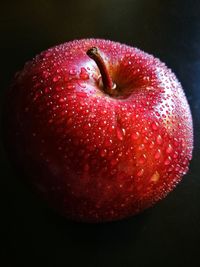 Close-up of strawberry over black background