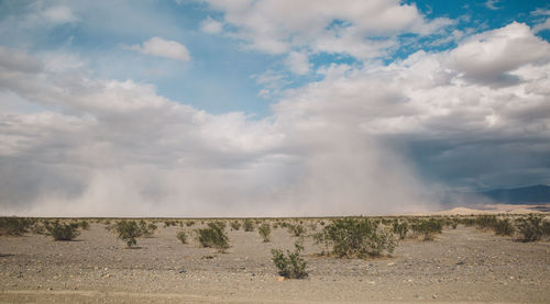 Scenic view of landscape against cloudy sky at death valley national park