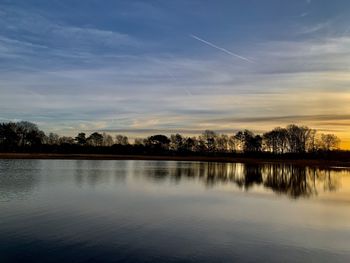 Scenic view of lake against sky during sunset