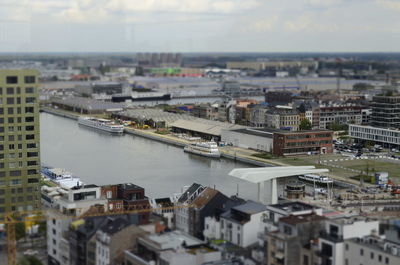 Tilt-shift image of cityscape against sky