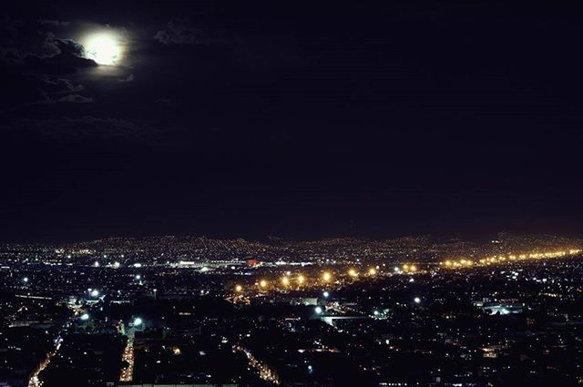 night, illuminated, cityscape, city, building exterior, architecture, built structure, crowded, dark, high angle view, aerial view, sky, copy space, residential district, city life, residential building, light, no people, outdoors, residential structure