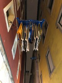 Low angle view of clothes drying on clothesline against building