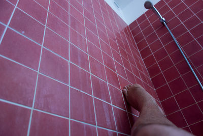 Low section of man with feet up in bathroom