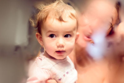 Close-up of cute baby and mother at home