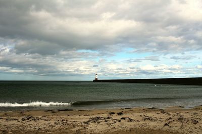 Scenic view of sea against cloudy sky