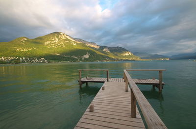 Pier over lake against sky