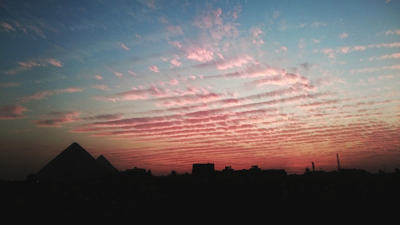 SILHOUETTE BUILDINGS AGAINST SKY AT SUNSET