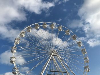 Low angle view of ferris wheel against sky