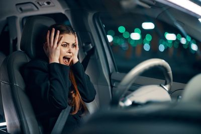 Woman screaming sitting in car