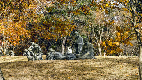 People relaxing in park during autumn