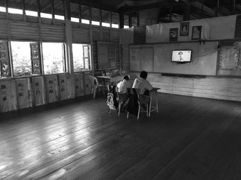 Rear view of people sitting on chair 