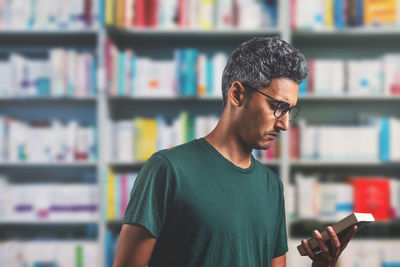 Man reading book in library