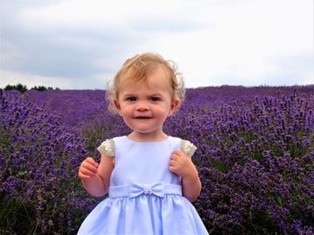 Portrait of cute girl standing on field