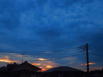 Silhouette electricity pylon against sky during sunset