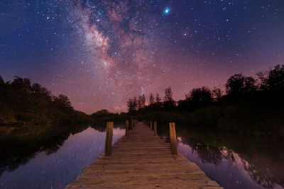 Scenic view of lake against sky at night