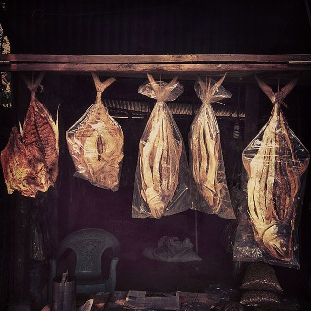 hanging, night, indoors, religion, wood - material, old, built structure, low angle view, architecture, abundance, no people, spirituality, art and craft, abandoned, large group of objects, place of worship, cultures, building exterior