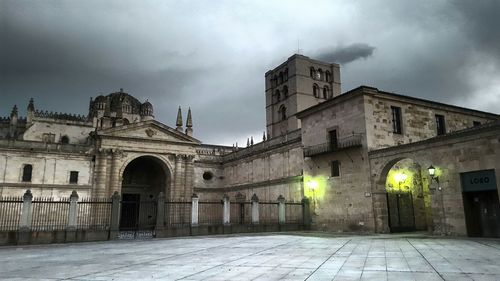 Buildings against cloudy sky