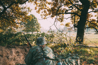 Rear view of army soldier in forest