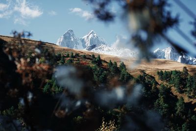 Scenic view of snowcapped mountains against sky