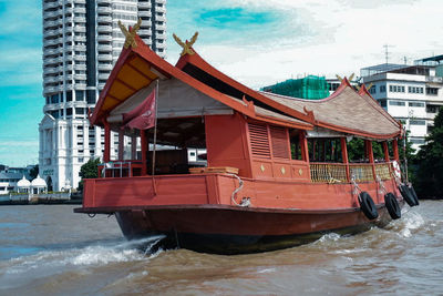 Boat moored at sea shore against sky