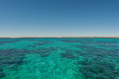 View of sea against clear blue sky