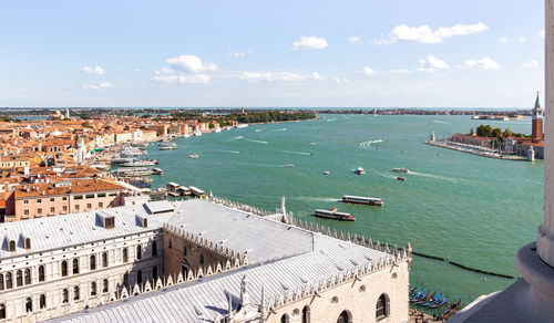 High angle view of buildings by sea against sky