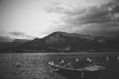 Scenic view of lake by mountains against sky