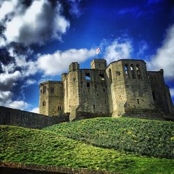 Low angle view of castle against cloudy sky