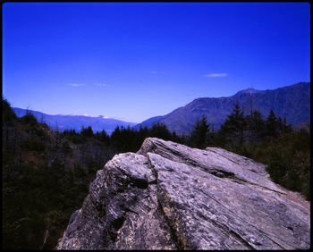 Scenic view of rocky mountains against clear blue sky