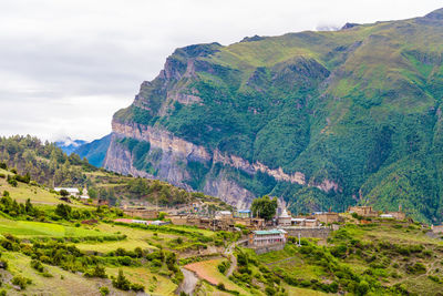 Scenic view of mountains against cloudy sky