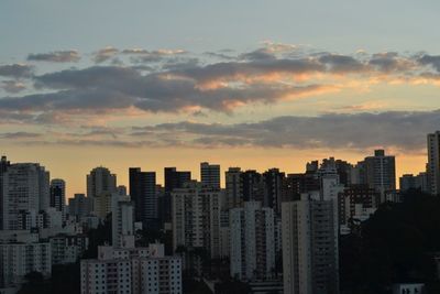 Cityscape against sky at sunset