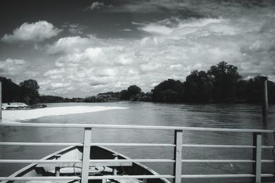 Pier on lake against cloudy sky