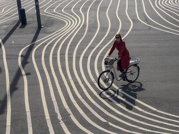 Portrait of woman riding bicycle on road in city