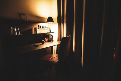 Illuminated electric lamp on table at home