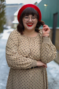 Portrait of smiling young woman with make-up standing outdoors