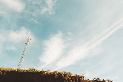 Low angle view of electricity pylon against sky