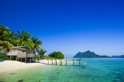 View of calm blue sea against mountain range