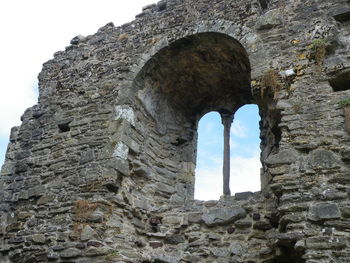 Low angle view of old ruin seen through hole