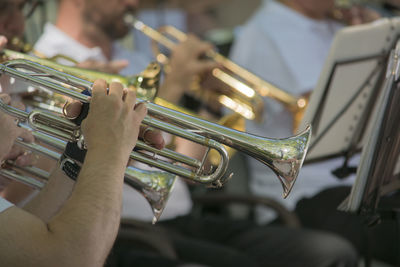 Midsection of people playing trumpet