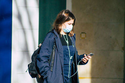 Young woman using mobile phone outdoors