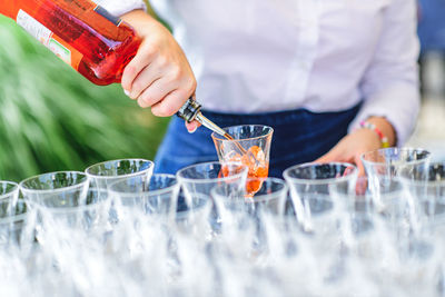Midsection of man holding drink
