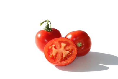 Close-up of tomatoes against white background