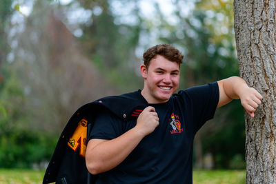 Portrait of young man standing in forest
