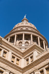 Low angle view of building against blue sky