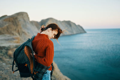 Man looking at sea against sky