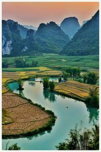 Scenic view of lake and mountains against clear sky