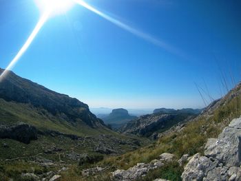 Scenic view of mountains against blue sky