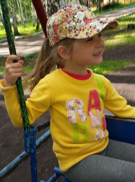 CUTE GIRL HOLDING BABY SITTING ON TREE